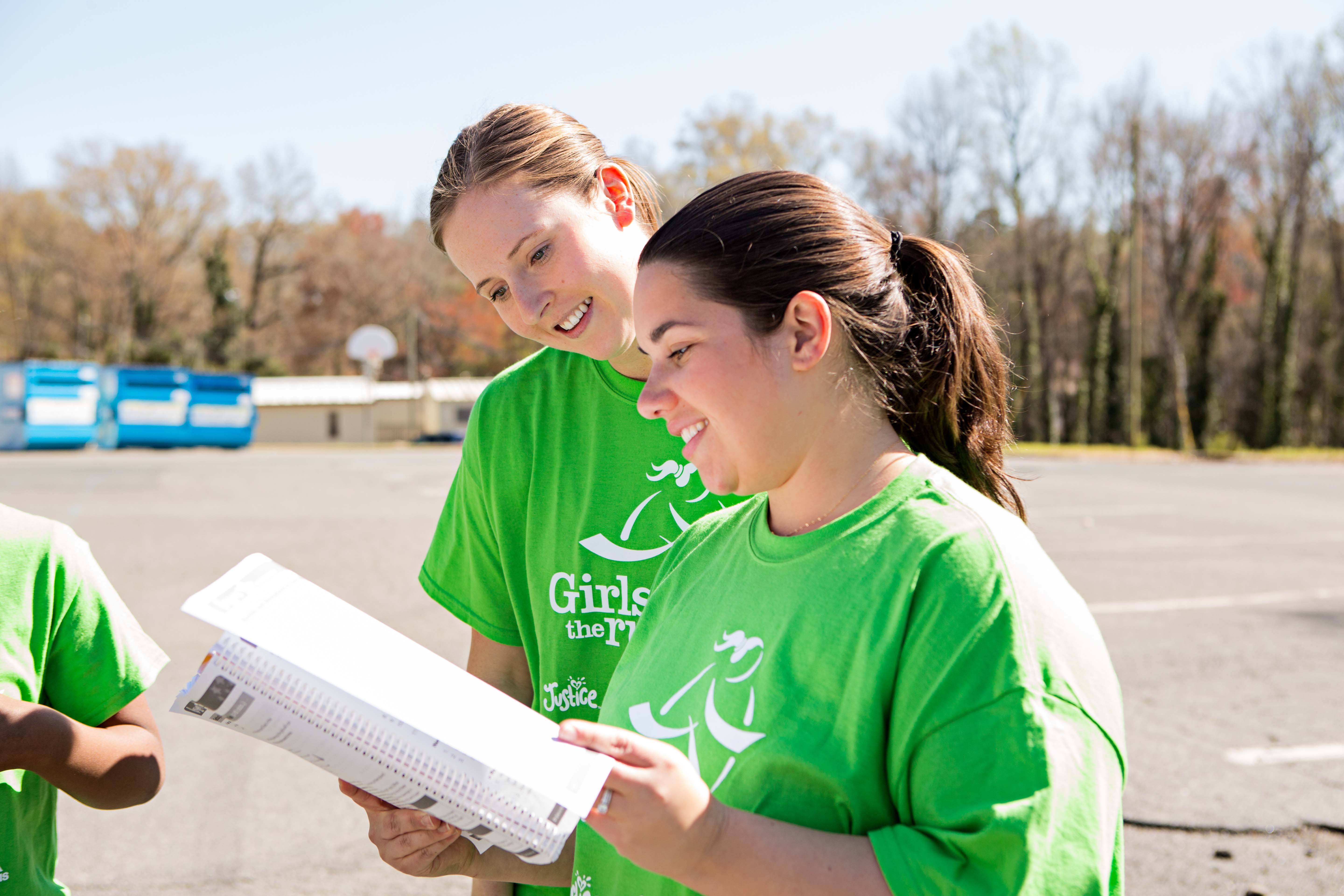 Smiling Girls on the Run Union County Coach talking with a participant